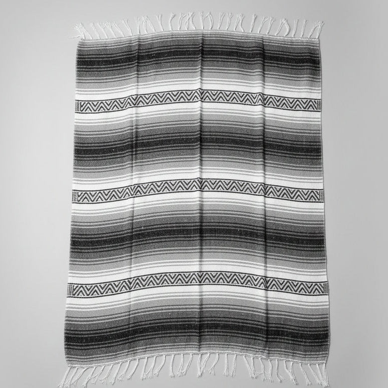 Black and white striped blanket on a gray background